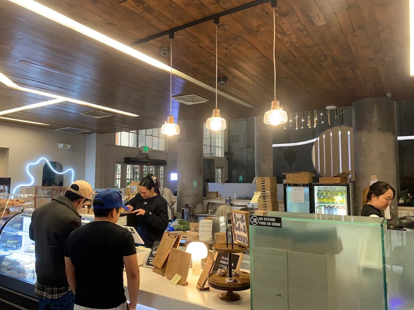 Friends laughing and drinking coffee in a modern cafe