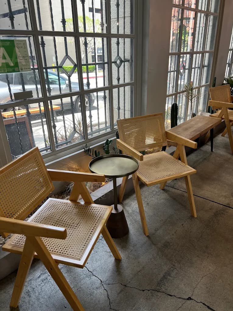 Friends laughing and drinking coffee in a modern cafe